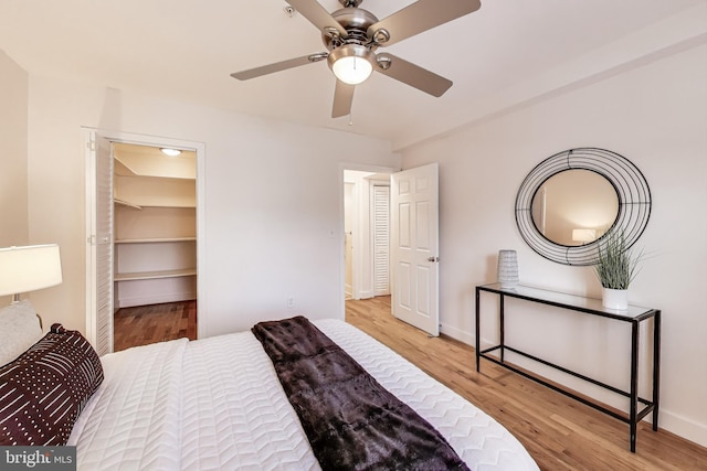 2615 4th St NE Unit 202, Washington, DC 20002 - bedroom featuring wood finished floors, ceiling fan, a walk in closet, and baseboards