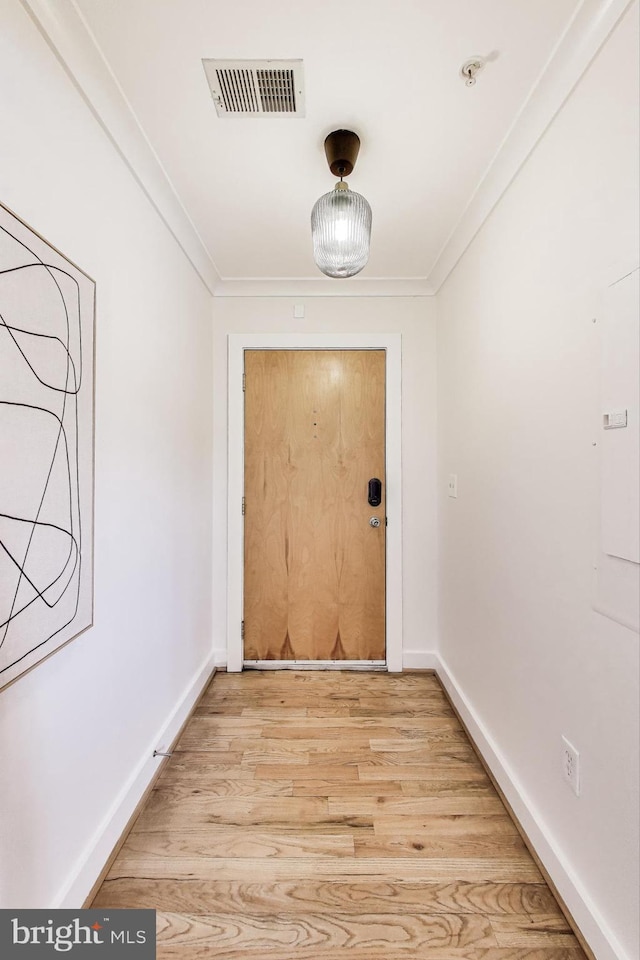 2615 4th St NE Unit 202, Washington, DC 20002 - doorway to outside with ornamental molding, light wood-style flooring, and baseboards