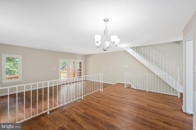 8530 Raglan Rd, Vienna, VA 22182 - spare room featuring wood finished floors, a chandelier, and plenty of natural light