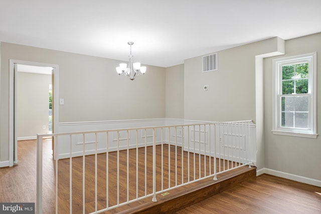 8530 Raglan Rd, Vienna, VA 22182 - empty room featuring wood finished floors and a chandelier