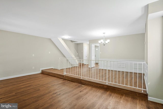 8530 Raglan Rd, Vienna, VA 22182 - unfurnished room featuring wood finished floors, a chandelier, and stairs
