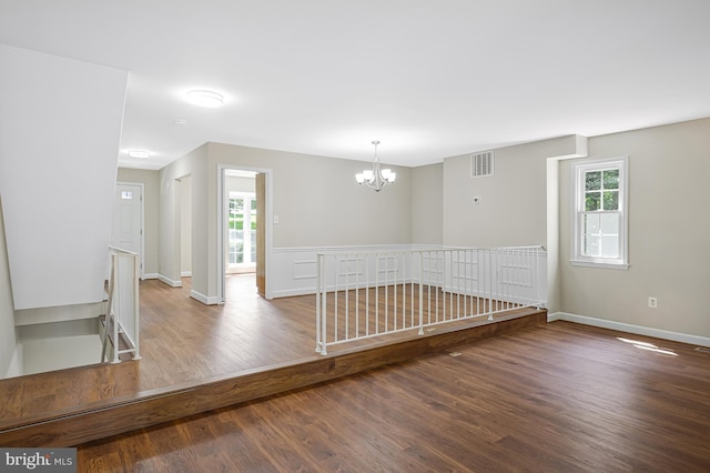 8530 Raglan Rd, Vienna, VA 22182 - spare room featuring a chandelier and wood finished floors
