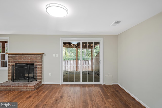 8530 Raglan Rd, Vienna, VA 22182 - unfurnished living room featuring wood finished floors, healthy amount of natural light, and a fireplace