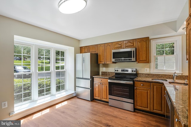 8530 Raglan Rd, Vienna, VA 22182 - kitchen with stainless steel appliances, brown cabinetry, and healthy amount of natural light