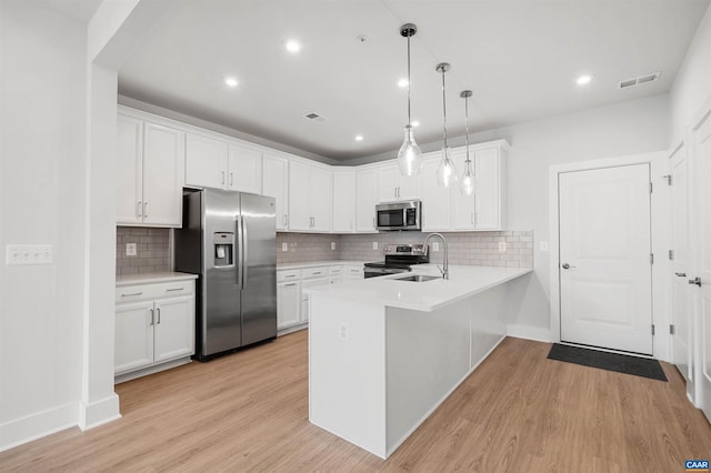 678 Noush Ct Unit A, Charlottesville, VA 22911 - kitchen featuring stainless steel appliances, a peninsula, a sink, light countertops, and recessed lighting