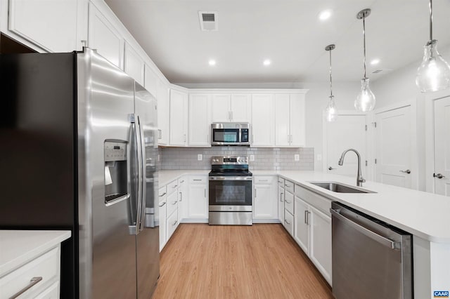678 Noush Ct Unit A, Charlottesville, VA 22911 - kitchen with stainless steel appliances, a sink, light wood-style flooring, a peninsula, and decorative backsplash