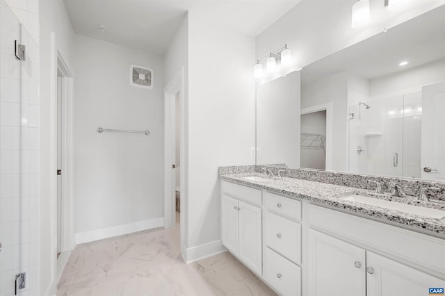 678 Noush Ct Unit A, Charlottesville, VA 22911 - bathroom featuring a shower stall, double vanity, a walk in closet, baseboards, and marble look tile flooring