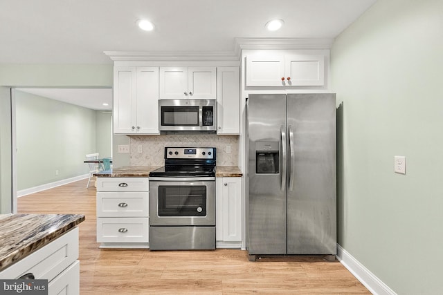 12542 Torquay Rd, Ocean City, MD 21842 - kitchen with stainless steel appliances, white cabinetry, decorative backsplash, recessed lighting, and light wood-style flooring