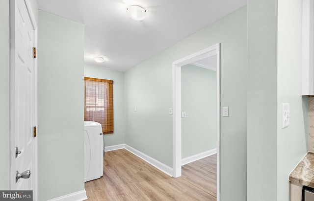 12542 Torquay Rd, Ocean City, MD 21842 - hallway featuring washer / dryer, light wood finished floors, and baseboards