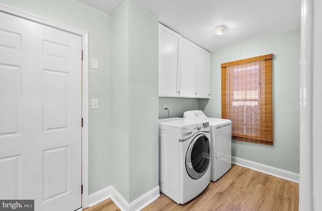 12542 Torquay Rd, Ocean City, MD 21842 - laundry room with washing machine and dryer, baseboards, light wood-type flooring, and cabinet space