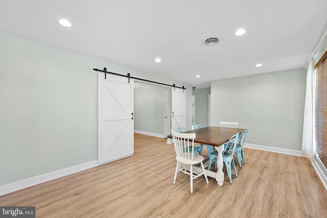 12542 Torquay Rd, Ocean City, MD 21842 - dining area with a barn door, light wood finished floors, baseboards, and recessed lighting