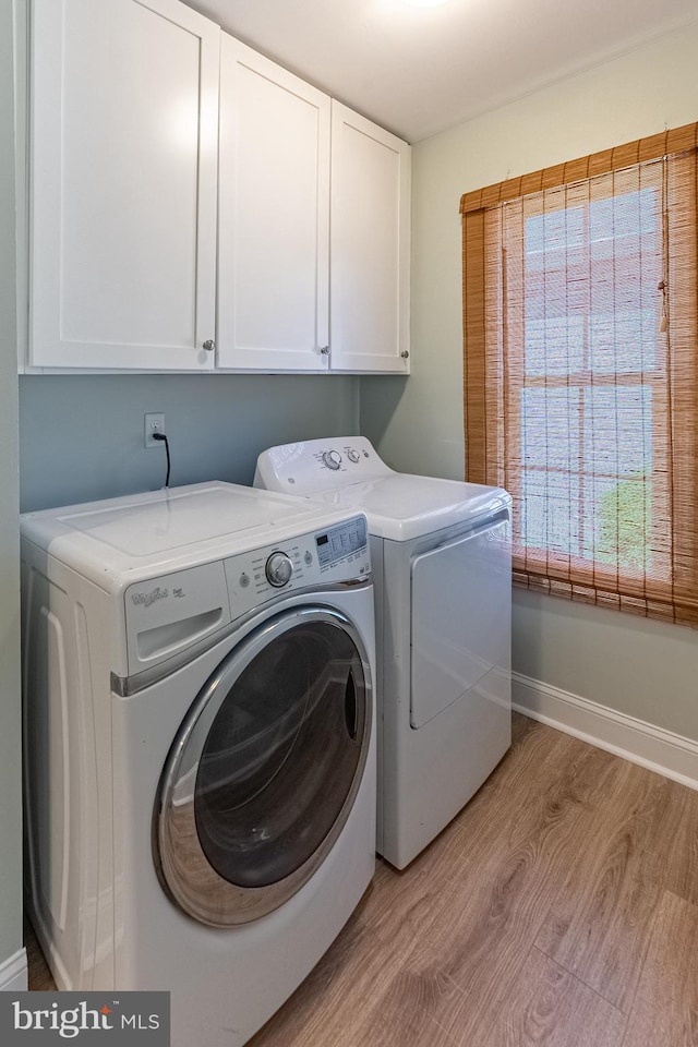 12542 Torquay Rd, Ocean City, MD 21842 - laundry area with cabinet space, washing machine and dryer, light wood-style flooring, and baseboards