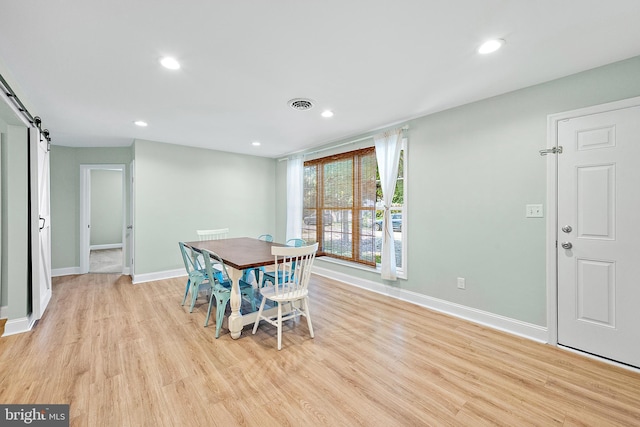 12542 Torquay Rd, Ocean City, MD 21842 - dining space with a barn door, light wood-style floors, baseboards, and recessed lighting