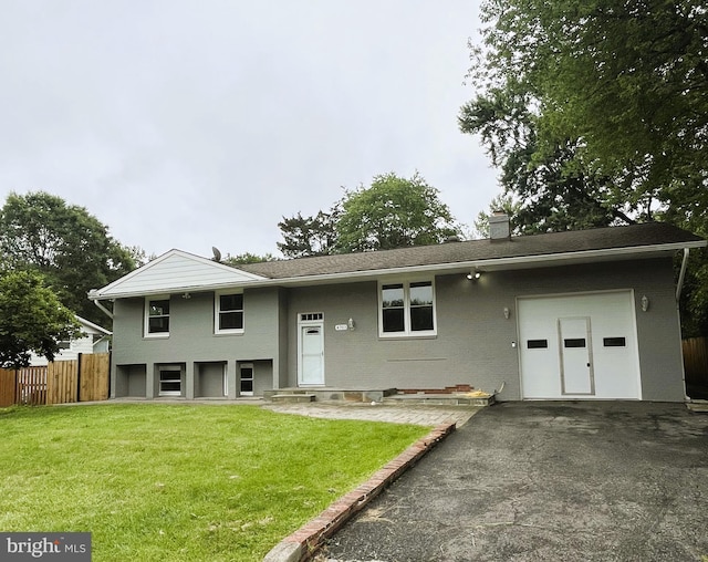 4703 Lawrence St, Alexandria, VA 22309 - view of front of house with a chimney, driveway, a garage, and brick siding