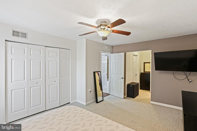 7810 Hanover Pkwy Unit 336, Greenbelt, MD 20770 - unfurnished bedroom with carpet flooring, baseboards, a closet, a textured ceiling, and ceiling fan