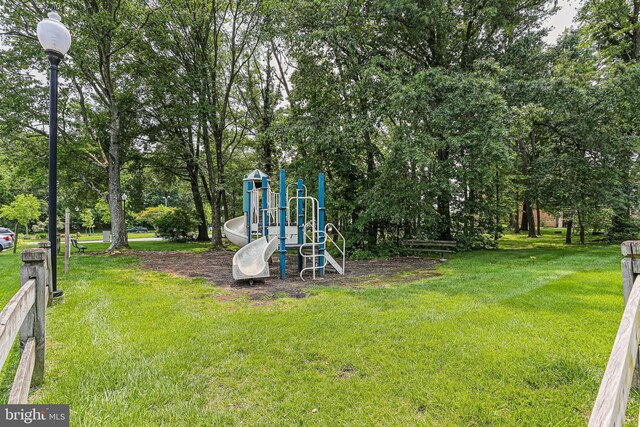 7810 Hanover Pkwy Unit 336, Greenbelt, MD 20770 - community playground featuring a lawn and view of wooded area
