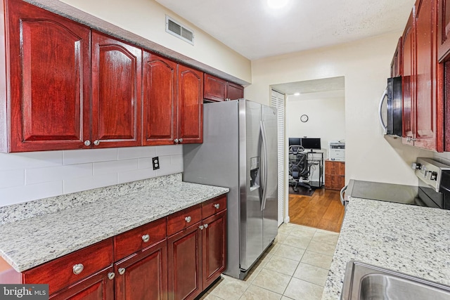 7810 Hanover Pkwy Unit 336, Greenbelt, MD 20770 - kitchen featuring reddish brown cabinets and appliances with stainless steel finishes