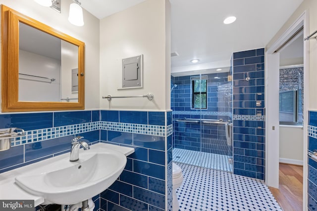3701 Connecticut Ave NW Unit 312/326, Washington, DC 20008 - bathroom featuring a shower stall, a sink, electric panel, recessed lighting, and tile walls