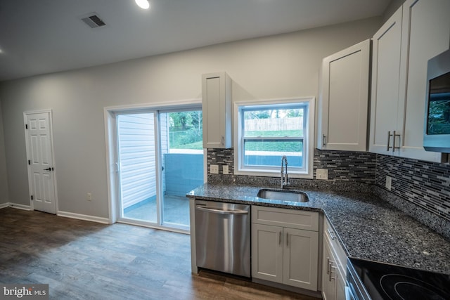 511 S Kent St, Winchester, VA 22601 - kitchen featuring stainless steel dishwasher, a sink, wood finished floors, tasteful backsplash, and dark stone counters