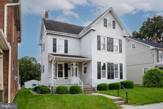 208 W N St, Waynesboro, PA 17268 - view of front facade featuring a porch, a chimney, a front yard, and a shingled roof