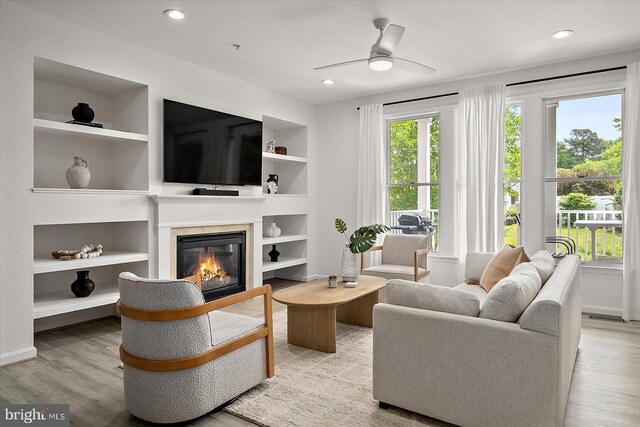214 October Glory Ave Unit 214G, Ocean View, DE 19970 - living area with built in shelves, a glass covered fireplace, a ceiling fan, wood finished floors, and recessed lighting