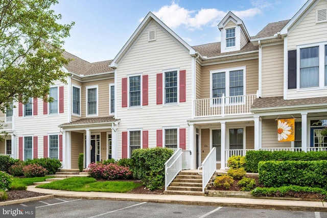 214 October Glory Ave Unit 214G, Ocean View, DE 19970 - view of property with uncovered parking, covered porch, and a shingled roof