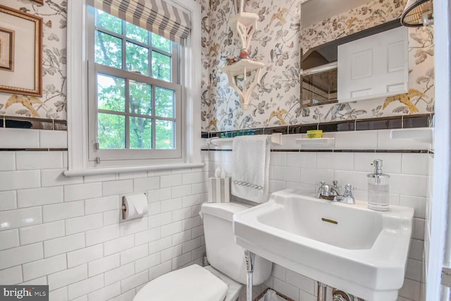 4212 Ingomar St NW, Washington, DC 20015 - bathroom featuring wallpapered walls, a sink, toilet, healthy amount of natural light, and tile walls