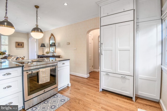 4212 Ingomar St NW, Washington, DC 20015 - kitchen featuring arched walkways, electric range, ornamental molding, white cabinets, and baseboards