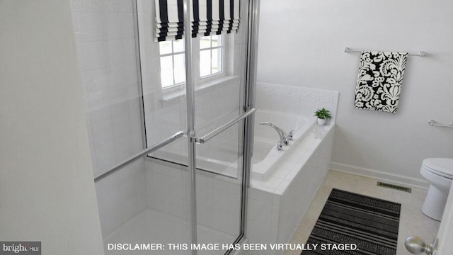 414 Bellflower Way Fallston Plan, Townsend, DE 19734 - bathroom featuring toilet, a bath, tiled shower, baseboards, and tile patterned floors