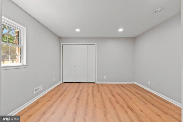 8818 Greens Ln, Randallstown, MD 21133 - unfurnished bedroom with wood finished floors, baseboards, recessed lighting, and a closet