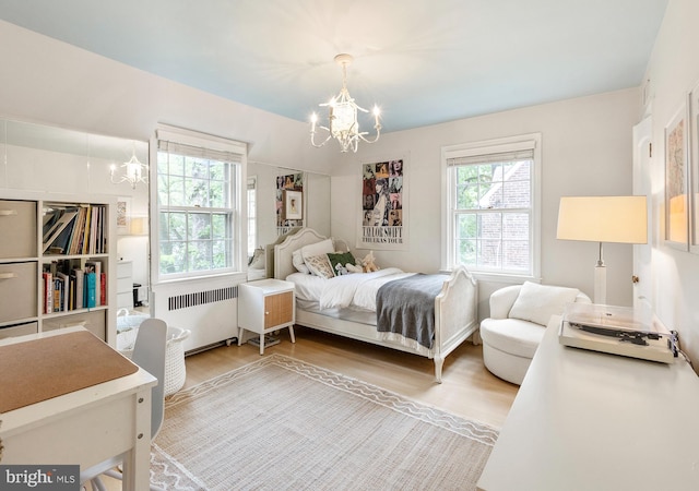 7006 Meadow Ln, Chevy Chase, MD 20815 - bedroom with radiator, a chandelier, multiple windows, and wood finished floors