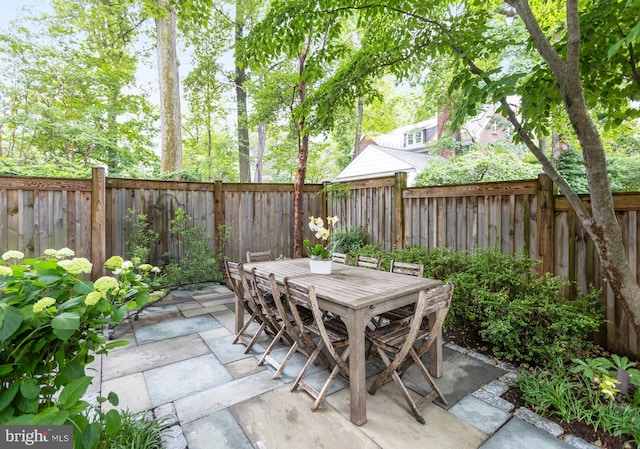 7006 Meadow Ln, Chevy Chase, MD 20815 - fenced backyard featuring outdoor dining space and a patio