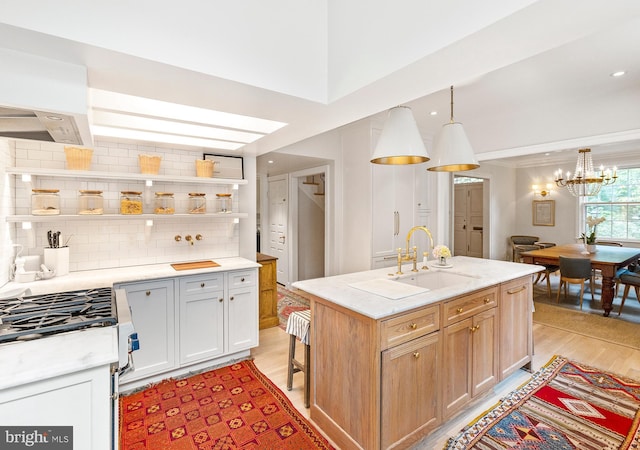 7006 Meadow Ln, Chevy Chase, MD 20815 - kitchen featuring stainless steel gas stove, tasteful backsplash, light wood finished floors, a chandelier, and open shelves