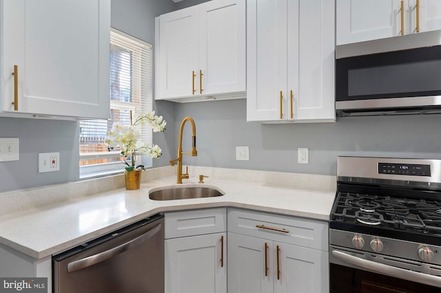 1513 N Wolfe St, Baltimore, MD 21213 - kitchen featuring stainless steel appliances, a sink, white cabinetry, and light stone countertops