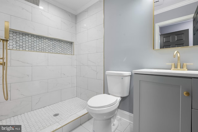 1513 N Wolfe St, Baltimore, MD 21213 - bathroom with ornamental molding, toilet, vanity, a tile shower, and baseboards