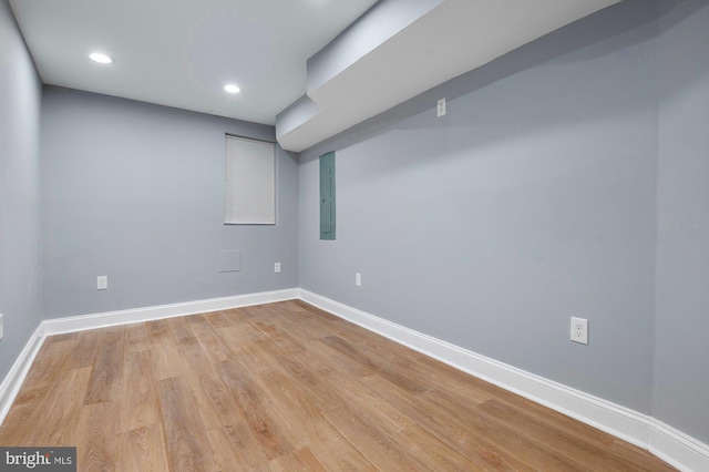 1513 N Wolfe St, Baltimore, MD 21213 - empty room with light wood finished floors, baseboards, electric panel, and recessed lighting
