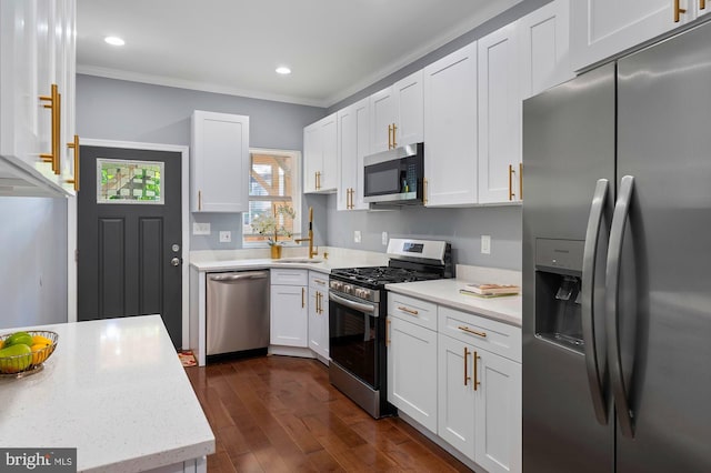 1513 N Wolfe St, Baltimore, MD 21213 - kitchen with appliances with stainless steel finishes, white cabinetry, crown molding, dark wood-style floors, and recessed lighting