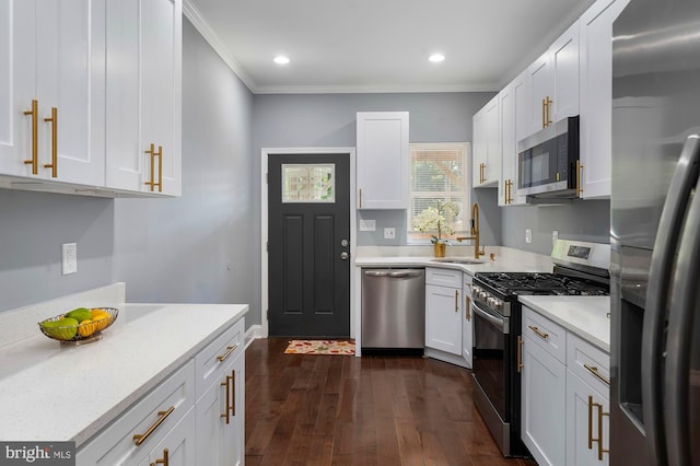1513 N Wolfe St, Baltimore, MD 21213 - kitchen with stainless steel appliances, a sink, ornamental molding, light countertops, and white cabinets