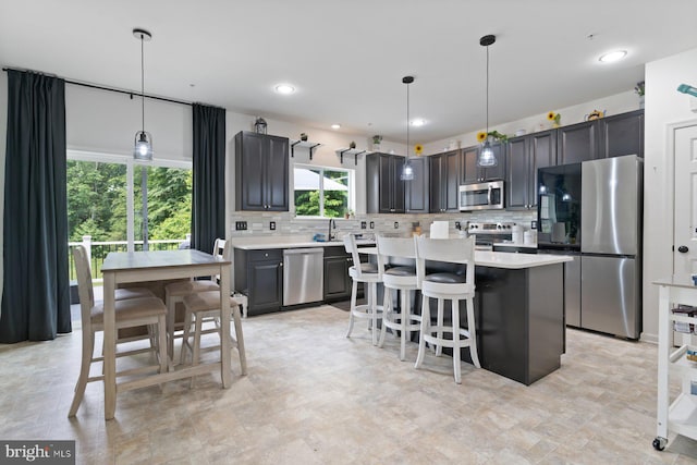 1408 Canopy Ln, Odenton, MD 21113 - kitchen with stainless steel appliances, tasteful backsplash, light countertops, a kitchen breakfast bar, and recessed lighting