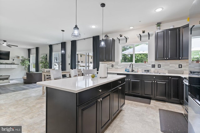 1408 Canopy Ln, Odenton, MD 21113 - kitchen with light countertops, open floor plan, backsplash, a center island, and recessed lighting