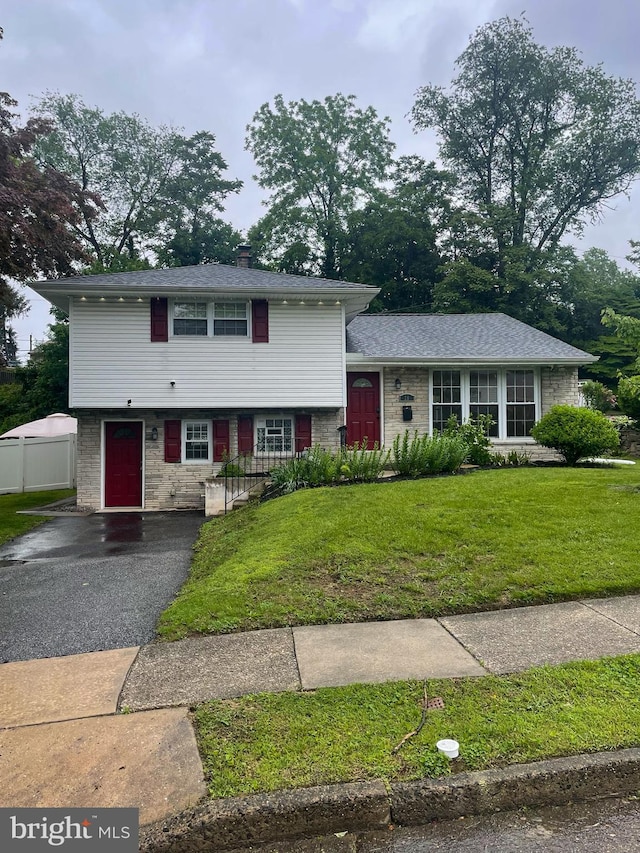 28 Eldon Ave, Lansdowne, PA 19050 - split level home with a front lawn, brick siding, and a chimney