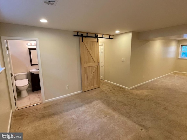 28 Eldon Ave, Lansdowne, PA 19050 - unfurnished bedroom with a barn door, carpet, recessed lighting, and connected bathroom