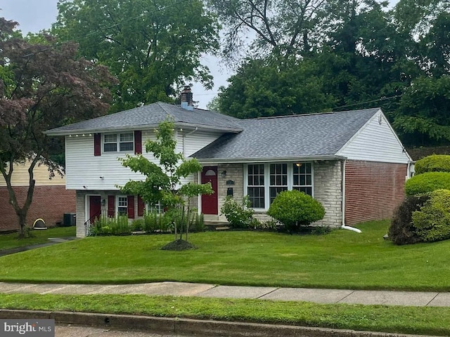 28 Eldon Ave, Lansdowne, PA 19050 - split level home featuring a chimney, a front lawn, and a shingled roof