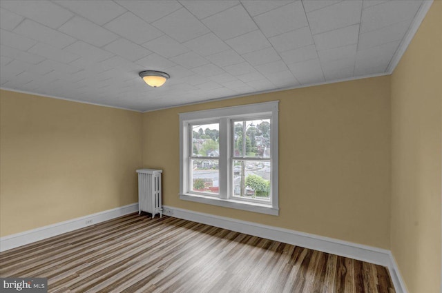 937 Fern Ave, Reading, PA 19607 - unfurnished room featuring wood finished floors, baseboards, radiator heating unit, and crown molding
