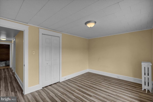 937 Fern Ave, Reading, PA 19607 - unfurnished bedroom with wood finished floors, baseboards, a closet, and crown molding