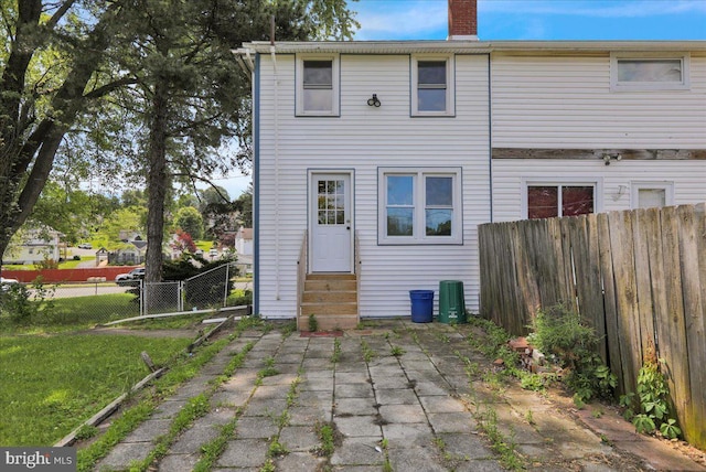 937 Fern Ave, Reading, PA 19607 - back of property featuring entry steps, a chimney, and a patio area
