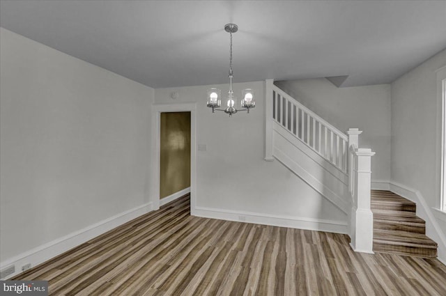 937 Fern Ave, Reading, PA 19607 - unfurnished dining area featuring stairs, a chandelier, baseboards, and wood finished floors