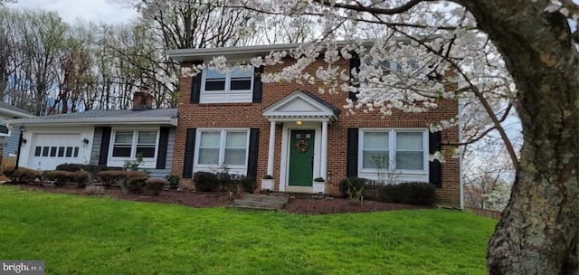 18924 Tributary Ln, Gaithersburg, MD 20879 - view of front of house featuring brick siding, a front lawn, a garage, and a chimney