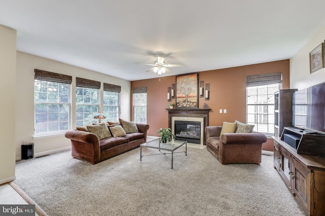 11211 Little Fox Ln, Germantown, MD 20876 - living area featuring healthy amount of natural light, a ceiling fan, a glass covered fireplace, and carpet flooring
