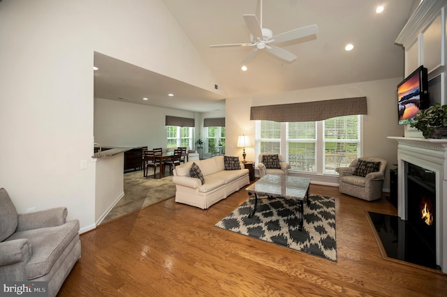 43 Battery Point Dr, Fredericksburg, VA 22406 - living area featuring a warm lit fireplace, a ceiling fan, recessed lighting, wood finished floors, and high vaulted ceiling